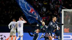 Paris Saint-Germain's Argentinian midfielder Leandro Paredes (R) celebrates after a goal during the UEFA Champions League round of 16 first leg football match between Paris Saint-Germain (PSG) and Real Madrid at the Parc des Princes stadium in Paris on February 15, 2022. (Photo by FRANCK FIFE / AFP)