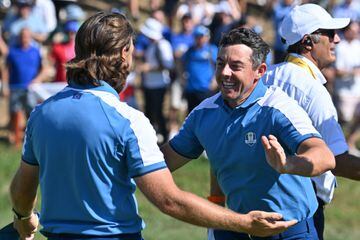 Rory McIlroy and Tommy Fleetwood celebrate their win over Xander Schauffele and Patrick Cantlay.