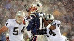 FOXBORO, UNITED STATES:  New England Patriots  quarterback Tom Brady (C) takes a hit from Charles Woodson (R) of the Oakland Raiders on a pass attempt in the last two minutes of the game in their AFC playoff 19 January 2002 in Foxboro, Massachusetts.  The Patriots won 16-13 in overtime. AFP PHOTO/Matt CAMPBELL (Photo credit should read MATT CAMPBELL/AFP/Getty Images)