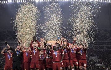 Jordan Henderson of Liverpool lifts the trophy as they celebrate victory following the FIFA Club World Cup Qatar 2019