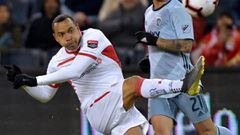Felipe Pardo (L) of Toluca hits the ball as Felipe Gutierrez of Sporting KC looks on during their CONCACAF Champions League game at Children&#039;s Mercy Park in Kansas City, Missouri on February 21, 2019. (Photo by Tim Vizer / AFP)