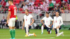 England's Harry Kane, James Justin and Mason Mount take a knee as Hungary's Adam Nagy (left) stands before the UEFA Nations League match at the Puskas Arena, Budapest.
