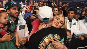 Canelo Alvarez hugs his girlfriend, Fernanda Gomez as their daughter, Maria, left, looks on, after defeating Billy Joe Saunders in a unified super middleweight world championship boxing match, Saturday, May 8, 2021, in Arlington, Texas. (AP Photo/Jeffrey McWhorter)