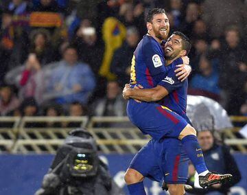 Barcelona's Argentinian forward Lionel Messi is congratulated by teammate Uruguayan forward Luis Suarez after scoring their team's fourth goal.
