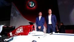 Charles Leclerc and Marcus Ericsson pose next to the Alfa Romeo Sauber.  