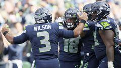 SEATTLE, WASHINGTON - SEPTEMBER 19: Russell Wilson #3 celebrates a touchdown by Freddie Swain #18 of the Seattle Seahawks against the Tennessee Titans during the fourth quarter at Lumen Field on September 19, 2021 in Seattle, Washington.   Steph Chambers/