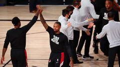Aug 20, 2020; Lake Buena Vista, Florida, USA; Portland Trail Blazers guard Damian Lillard (second from left) reacts as he is introduced before a NBA basketball first round playoff game against the Los Angeles Lakers in the 2020 NBA playoffs at AdventHealt