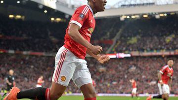 Manchester United&#039;s French striker Anthony Martial celebrates after scoring their first goal during the English FA Cup quarter final football match between Manchester United and West Ham United at Old Trafford in Manchester, north west England, on Ma