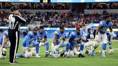 Members of the Los Angeles Chargers kneel as Donald Parham #89 of the Los Angeles Chargers is assessed for injury in the first quarter of the game against the Kansas City Chiefs at SoFi Stadium on December 16, 2021 in Inglewood, California.  