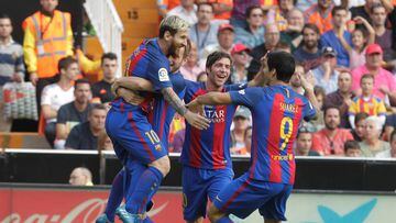 Barcelona's Lionel Messi (L) celebrates with team mates after he scored a goal agianst Valencia. REUTERS/Heino Kalis