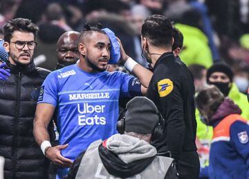 Marseille's French midfielder Dimitri Payet (C) leaves the field after having received a bottle of water from the grandstand during the French L1 football match between Olympique Lyonnais and Olympique de Marseille at the Groupama stadium in Decines-Charp