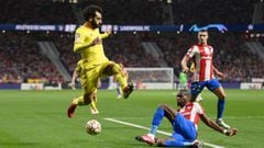 MADRID, SPAIN - OCTOBER 19: Mohamed Salah of Liverpool evades a tackle from Geoffrey Kondogbia of Atletico Madrid during the UEFA Champions League group B match between Atletico Madrid and Liverpool FC at Wanda Metropolitano on October 19, 2021 in Madrid,