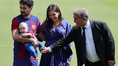 (From L) FC Barcelona's newly-signed German midfielder Ilkay Gundogan poses for pictures with his newborn son, his wife Sara Arfaoui and FC Barcelona's President Joan Laporta during his official presentation at the Joan Gamper training ground in Sant Joan Despi on July 17, 2023. (Photo by LLUIS GENE / AFP)