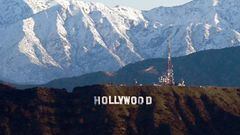Snow capped mountains stand on the skyline behind a view of the Hollywood sign following heavy rain from winter storms, as seen from the Kenneth Hahn State Recreation Area, on March 2, 2023, in Los Angeles, California. (Photo by Patrick T. Fallon / AFP) (Photo by PATRICK T. FALLON/AFP via Getty Images)