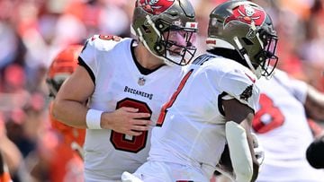 Baker Mayfield, #6 of the Tampa Bay Buccaneers, hands the ball off to Rachaad White #1 of the Tampa Bay Buccaneers