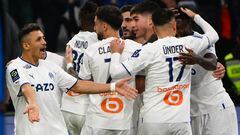 Marseille's players celebrate after scoring a goal during the French L1 football match between Olympique de Marseille (OM) and Stasbourg (RC Stasbourg) at the Velodrome stadium in Marseille, southern France on March 12, 2023. (Photo by CHRISTOPHE SIMON / AFP)