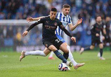 Manchester City's Joao Cancelo in action with Brighton & Hove Albion's Jakub Moder Pool.