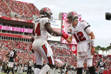 Sep 19, 2021; Tampa, Florida, USA; Tampa Bay Buccaneers wide receiver Chris Godwin (14) is congratulated by quarterback Tom Brady (12) after he scored a touchdown against the Atlanta Falcons during the second half at Raymond James Stadium. Mandatory Credi