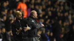 Manchester City&#039;s Spanish manager Pep Guardiola (L) and Wigan Athletic&#039;s English Manager Paul Cook gesture during the English FA Cup fifth round football match between Wigan Athletic and Manchester City at the DW Stadium in Wigan, northwest Engl
