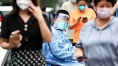 BEIJING, CHINA - JUNE 14: A guard wears protective clothing as he looks on at a COVID-19 test site on June 14, 2022 in Beijing, China. China is trying to contain a spike in coronavirus cases in the capital Beijing, Local authorities have initiated mass testing in most districts, placing some neighborhoods under lockdown where cases are found in an effort to prevent the spread of COVID-19. (Photo by Lintao Zhang/Getty Images)