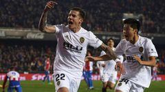 VALENCIA, SPAIN - JANUARY 15: Santi Mina of Valencia CF celebrates after scoring his sides first goal with his teammate Kangin Lee during the Copa del Rey Round of 16  second leg match between Valencia CF and Sporting Gijon at Estadio Mestalla on January 