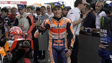 Spain&#039;s Honda biker Marc Marquez celebrates after obtaining the pole position of the MotoGP during the qualifying session of the Argentina Grand Prix at the Termas de Rio Hondo circuit in Santiago del Estero, Argentina, on March 30, 2019. - At right,