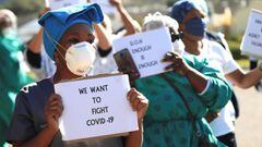 Health care workers holding signs protest over the lack of personal protective equipment during the coronavirus outbreak, outside a hospital in Cape Town, South Africa.