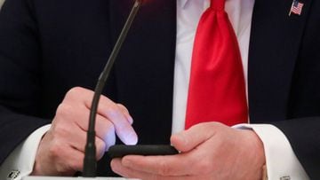 U.S. President Donald Trump taps his mobile phone during a roundtable discussion at the White House in Washington. 