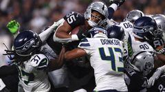 Aug 14, 2021; Paradise, Nevada, USA; Las Vegas Raiders running back B.J. Emmons (35) jumps over the line of scrimmage to score a touchdown as Seattle Seahawks safety Joshua Moon (37) and linebacker Aaron Donkor (43) defend during the second half at Allegi