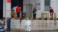 FILE PHOTO: A worker in PPE stands in Baishazhou market during a visit of World Health Organization (WHO) team tasked with investigating the origins of the coronavirus (COVID-19) pandemic, in Wuhan, Hubei province, China, Jan. 31, 2021. REUTERS/Thomas Peter/File Photo