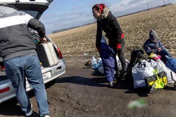 A family loads belongings into a car on the side of a road close to Kropyvnytskyi as they flee from the danger area.