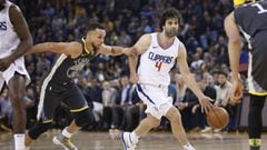 Feb 22, 2018; Oakland, CA, USA; Los Angeles Clippers guard Milos Teodosic (4) dribbles away from Golden State Warriors guard Stephen Curry (30) in the first quarter at Oracle Arena. Mandatory Credit: Cary Edmondson-USA TODAY Sports