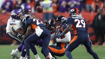 DENVER, COLORADO - NOVEMBER 19: Quarterback Joshua Dobbs #15 of the Minnesota Vikings fumbles the football after being hit by safety Kareem Jackson #22 of the Denver Broncos during the first quarter of the NFL game at Empower Field At Mile High on November 19, 2023 in Denver, Colorado.   Matthew Stockman/Getty Images/AFP (Photo by MATTHEW STOCKMAN / GETTY IMAGES NORTH AMERICA / Getty Images via AFP)