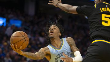 May 7, 2022; San Francisco, California, USA; Memphis Grizzlies guard Ja Morant (12) shoots the ball against Golden State Warriors forward Kevon Looney (5) during the fourth quarter of game three of the second round for the 2022 NBA playoffs at Chase Center. Mandatory Credit: D. Ross Cameron-USA TODAY Sports