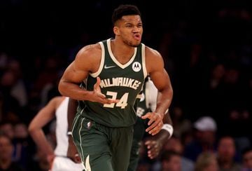 NEW YORK, NEW YORK - DECEMBER 12: Giannis Antetokounmpo #34 of the Milwaukee Bucks celebrates after teammate Bobby Portis #9 made a shot off his assist in the first half at Madison Square Garden on December 12, 2021 in New York City.