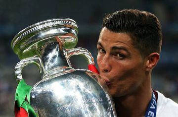 Cristiano Ronaldo kisses the Euro trophy he was determined to win with his country.