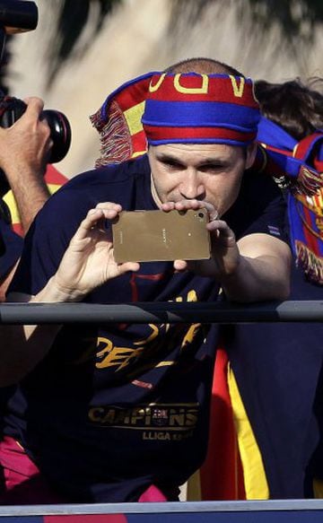 Andrés Iniesta whips out an expensive-looking mobile telephone as he makes sure to get a photo/video of the merriment.