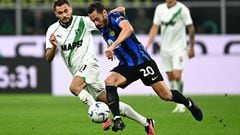 Sassuolo's Albanian midfielder #11 Nedim Bajrami (L) fights for the ball with Inter Milan's Turkish midfielder #20 Hakan Calhanoglu during the Italian Serie A football match between Inter Milan and Sassuolo at the San Siro stadium in Milan on September 27, 2023. (Photo by GABRIEL BOUYS / AFP)