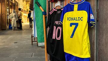 The football jerseys of Portugal's forward #7 Cristiano Ronaldo with his new Saudi club al-Nassr and Argentina's forward #10 Lionel Messi with his new US club Inter Miami CF are displayed for sale at a vendor's stall at Qatar's touristic Souq Waqif bazar in Doha on August 7, 2023. (Photo by KARIM JAAFAR / AFP)