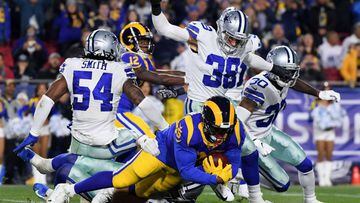 LOS ANGELES, CA - JANUARY 12: C.J. Anderson #35 of the Los Angeles Rams is tackled by Leighton Vander Esch #55 of the Dallas Cowboys in the first quarter in the NFC Divisional Playoff game at Los Angeles Memorial Coliseum on January 12, 2019 in Los Angele