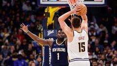 Nov 6, 2023; Denver, Colorado, USA; Denver Nuggets center Nikola Jokic (15) attempts a shot as New Orleans Pelicans forward Zion Williamson (1) guards in the first quarter at Ball Arena. Mandatory Credit: Isaiah J. Downing-USA TODAY Sports