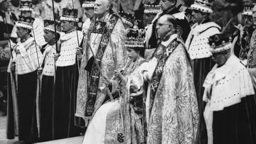 2nd June 1953:  Queen Elizabeth II seated upon the throne at her coronation in Westminster Abbey, London.  She is holding the royal sceptre (ensign of kingly power and justice) and the rod with the dove (symbolising equity and mercy).  (Photo by Topical Press Agency/Getty Images)
