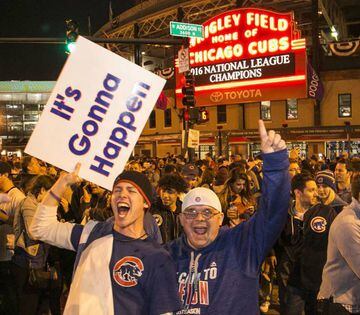 Chicago Cubs fans celebrate outside Wrigley Field