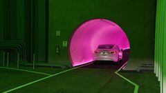 LAS VEGAS, NEVADA - APRIL 09: A Tesla car drives through a tunnel in the Central Station during a media preview of the Las Vegas Convention Center Loop on April 9, 2021 in Las Vegas, Nevada. The Las Vegas Convention Center Loop is an underground transport