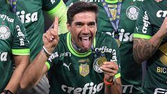 Palmeiras' Portuguese coach Abel Ferreira (C) celebrates with the trophy after winning the Brazilian Championship following the football match between Cruzeiro and Palmeiras at Minerao stadium in Belo Horizonte, Brazil, on December 6, 2023. (Photo by DOUGLAS MAGNO / AFP)