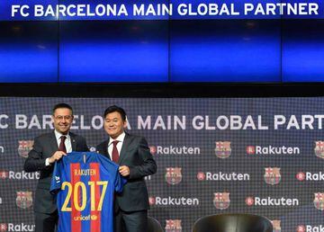 Barcelona's president Josep Maria Bartomeu (L) and CEO of Japanese company Rakuten Hiroshi Mikitani display the FC Barcelona's new jersey after signing an agreement between FC Barcelona and Rakuten Inc., at Camp Nou stadium in Barcelona on November 16, 20