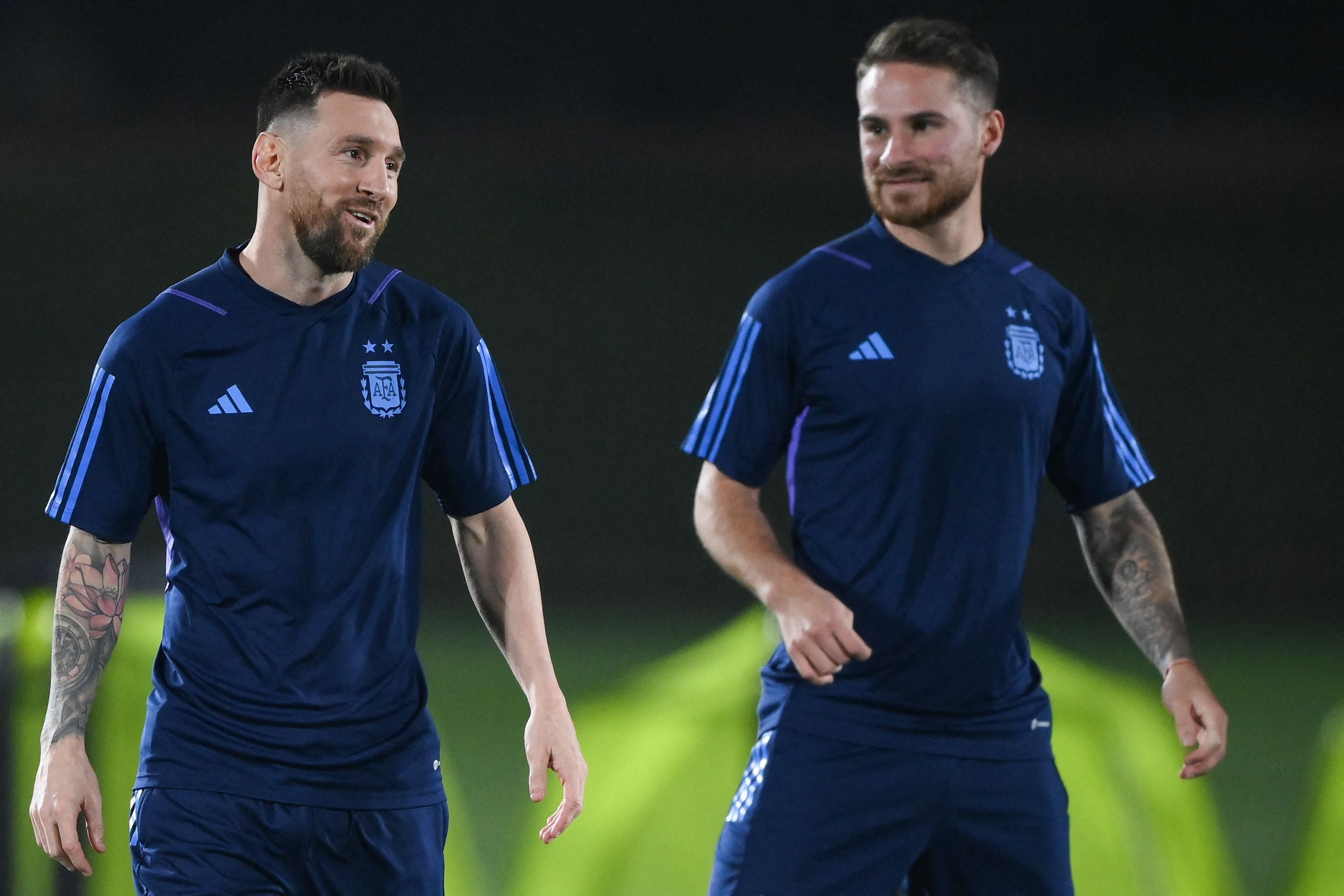 Argentina's forward #10 Lionel Messi (L) and Argentina's midfielder #20 Alexis Mac Allister take part in a training session at Qatar University training site 3 in Doha on December 17, 2022, on the eve of the Qatar 2022 World Cup football final match between Argentina and France. (Photo by FRANCK FIFE / AFP)