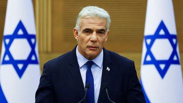 FILE PHOTO: Israeli Foreign Minister Yair Lapid speaks next to Prime Minister Naftali Bennett (not pictured) as they give a statement at the Knesset, Israel's parliament, in Jerusalem, June 20, 2022. REUTERS/Ronen Zvulun/File Photo