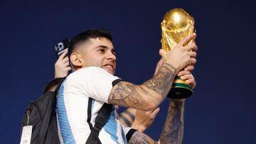 Soccer Football - FIFA World Cup Qatar 2022 - Final - Argentina v France - Lusail, Qatar - December 19, 2022 Argentina's Cristian Romero celebrates with trophy on a bus after winning the World Cup REUTERS/Thaier Al-Sudani
