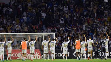 Pumas's players celebrates with their supporters after defeating Cruz Azul during their second leg semi-final CONCACAF Champions League football match at Azteca stadium in Mexico City, April 12, 2022. (Photo by ALFREDO ESTRELLA / AFP)
